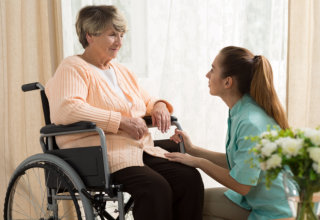 caregiver and old woman having a conversation